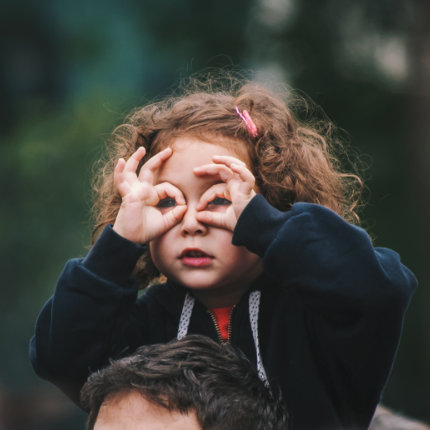 Child on fathers shoulder